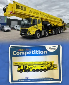 Large yellow truck mount at a competition, branding visible on the vehicle and banner in the foreground.